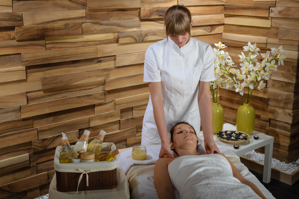 Woman enjoying neck massage at luxury spa