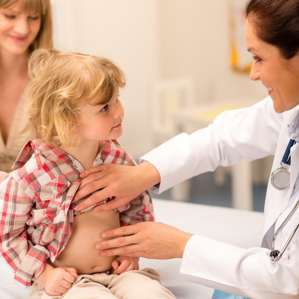 Pediatrician examine child tummy at office