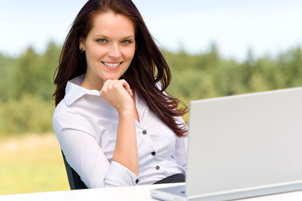 Businesswoman in sunny nature with laptop smile
