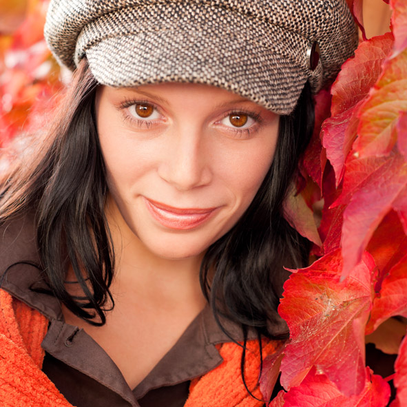 Portrait Autumn fashion young woman in front of red colored wild wine leafs