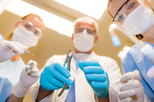 Professional dental team in action bottom view