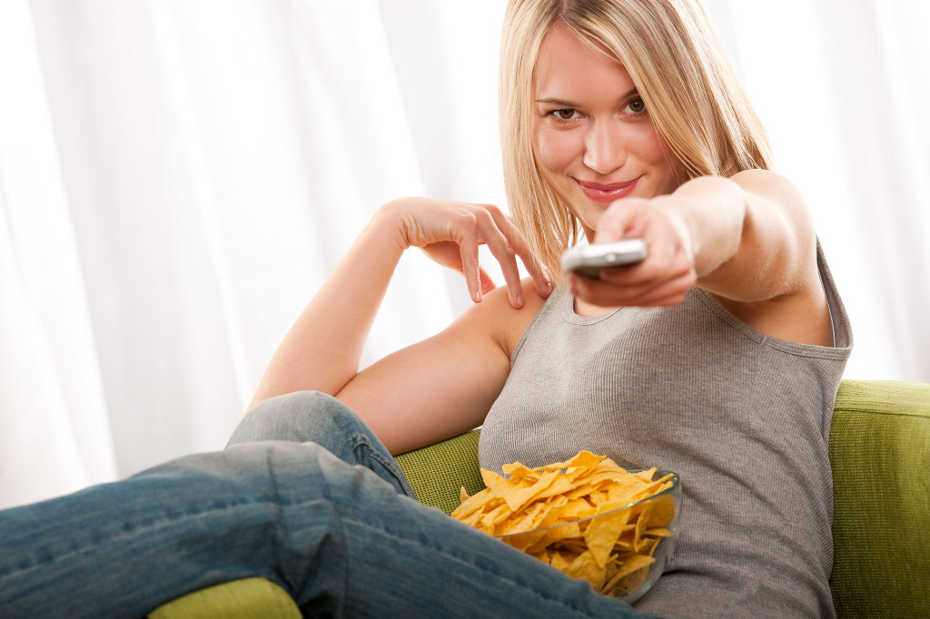 Young woman with remote control